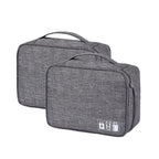 Two gray travel bags with USB charging ports on a white background