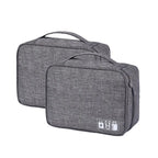 Two gray travel bags with USB charging ports on a white background