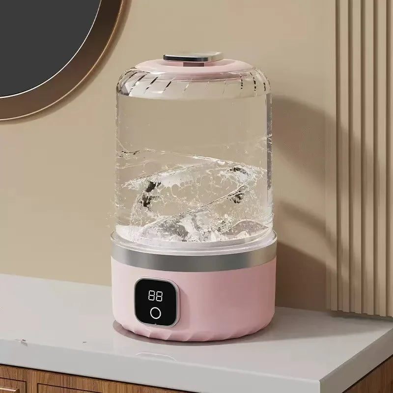 Pink and clear humidifier on a white surface with a neutral wall background
