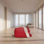 Red handbag with a patterned strap on a white background
