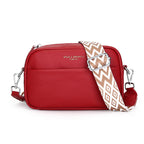 Red handbag with a patterned strap on a white background