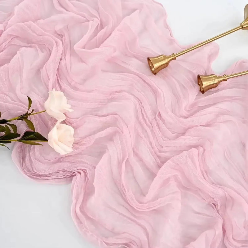 Pink fabric with gold candlesticks and white flowers on a light background