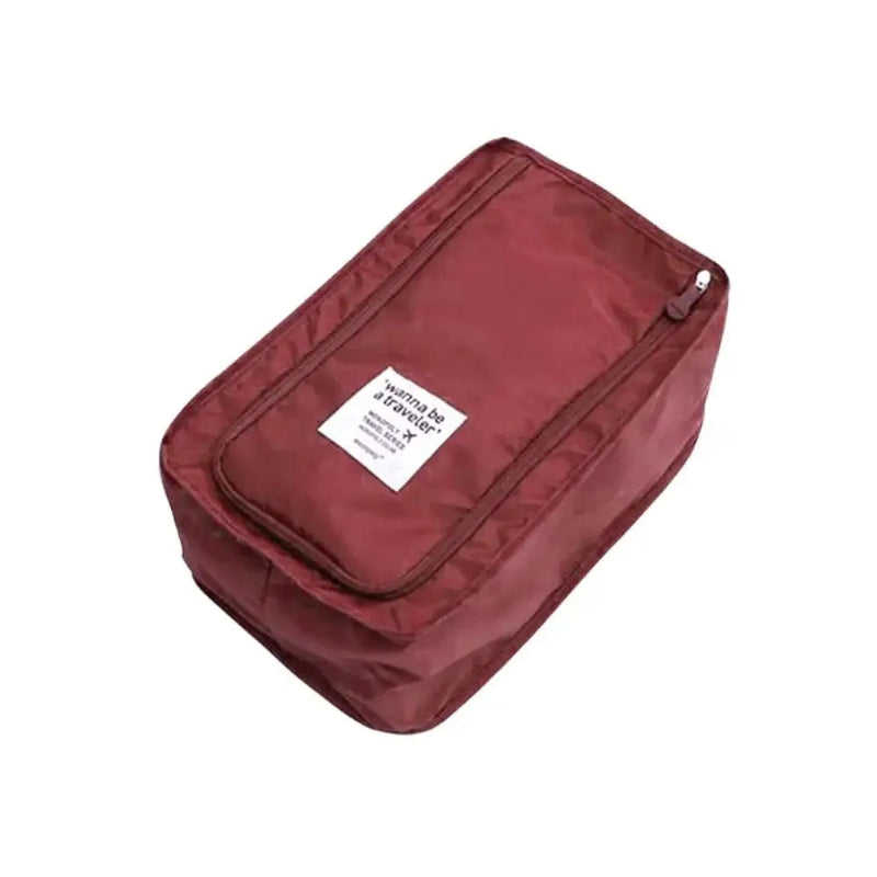 Maroon travel packing cube with a label on a white background