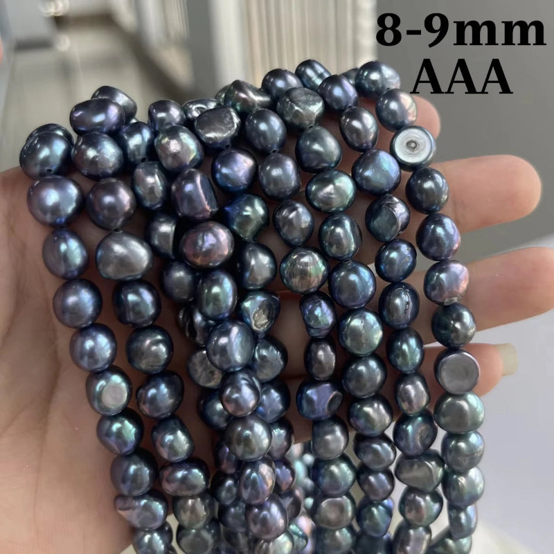 A hand holding multiple strands of iridescent baroque pearl beads, with text overlay reading '8-9mm AAA' in the top right corner.