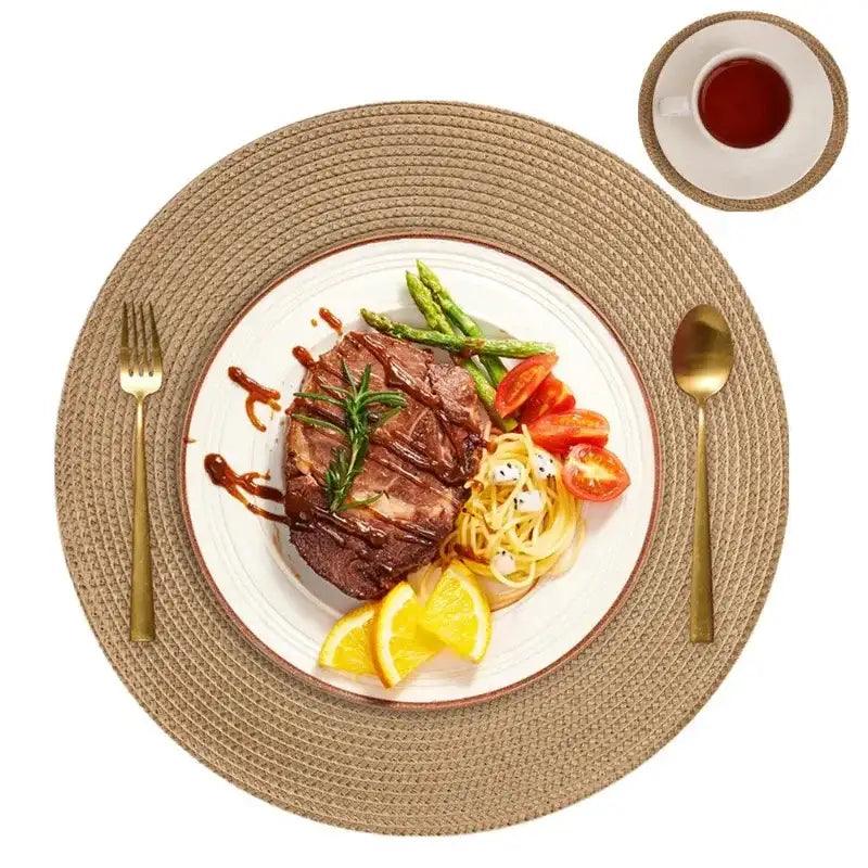 Steak with vegetables on a white plate with cutlery and a cup of tea.