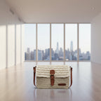 Woven handbag with leather strap and buckle on a white background
