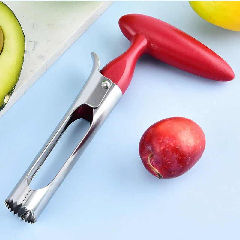 Red and silver fruit peeler on a light blue surface with a red apple and green bananas.