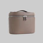 Brown leather travel case with zipper on a white background