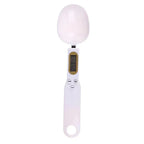 Digital kitchen scale with a white bowl on a white background