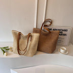 Two woven bags with brown handles on a white surface with a minimal background.