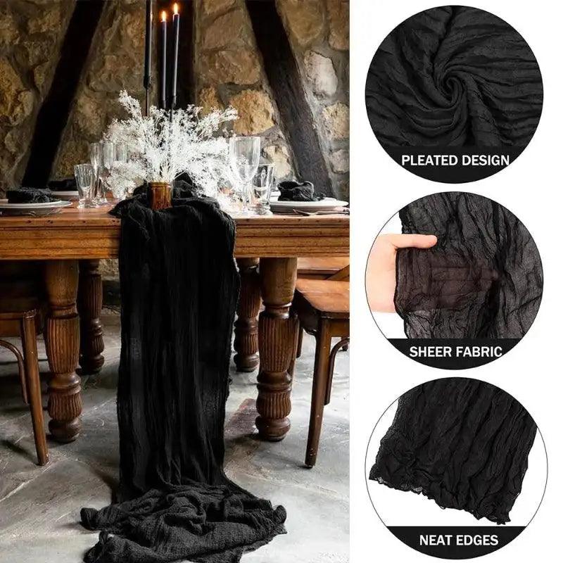 Black pleated table runner on a wooden table with stone wall background