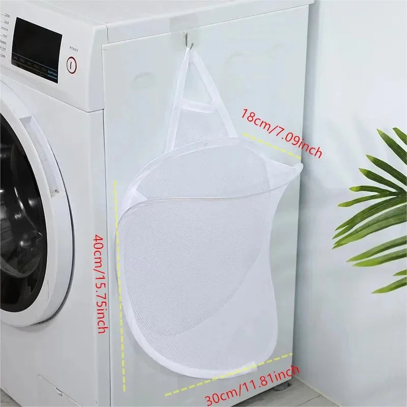 White mesh laundry bag with dimensions displayed in front of a washing machine.