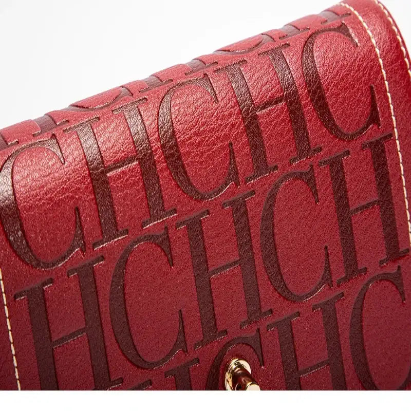 Red handbag with 'CHIC' text pattern on a white background