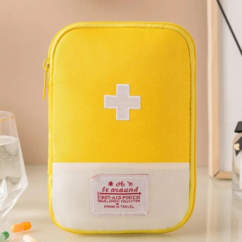 Yellow first aid kit with a white cross on a beige background
