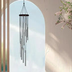Wind chime hanging against a light blue sky with a blurred background