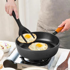 Person cooking eggs in a frying pan on a stove