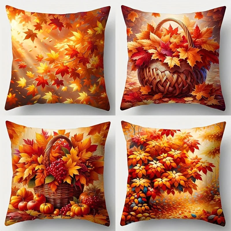 Four decorative pillows with autumn-themed designs featuring leaves, pumpkins, and a basket.