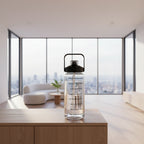 Clear water bottle with black lid on a wooden table in a cafe setting