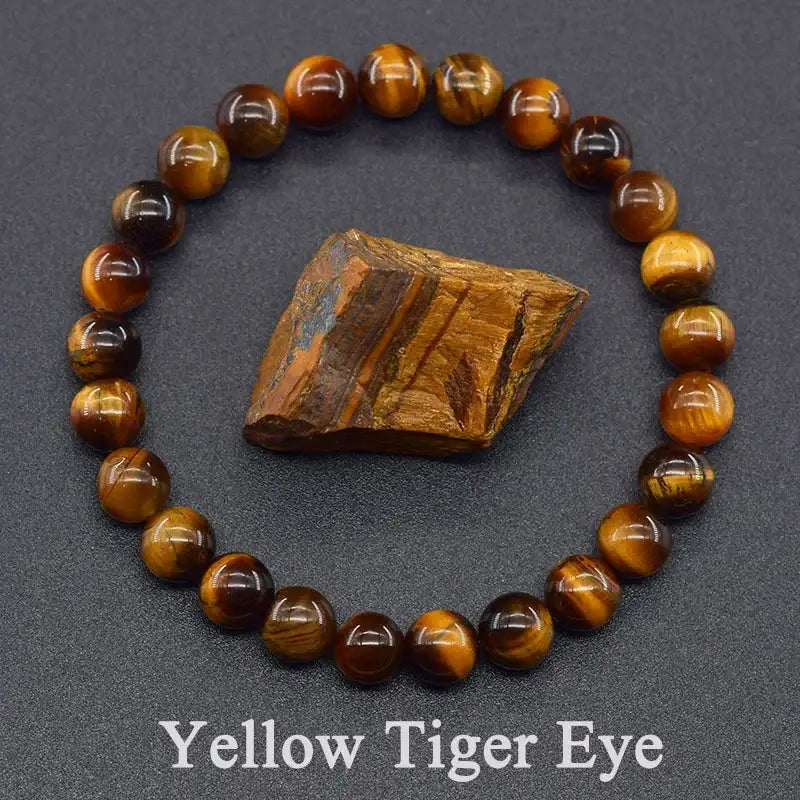 Yellow tiger eye bracelet with a piece of tiger eye stone on a dark gray background