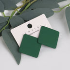 Green square earrings on a white card with 'Jewelry by Korea' branding, surrounded by green leaves.
