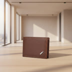 Brown leather wallet with a strap on a wooden surface