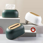 Three modern tissue holders in green, white, and beige on a neutral background