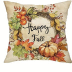 Decorative pillow with autumn-themed design featuring pumpkins, leaves, and 'Happy Fall' text.