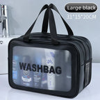 Black washbag with transparent front panel displaying products, placed on a white surface with a bathroom background.