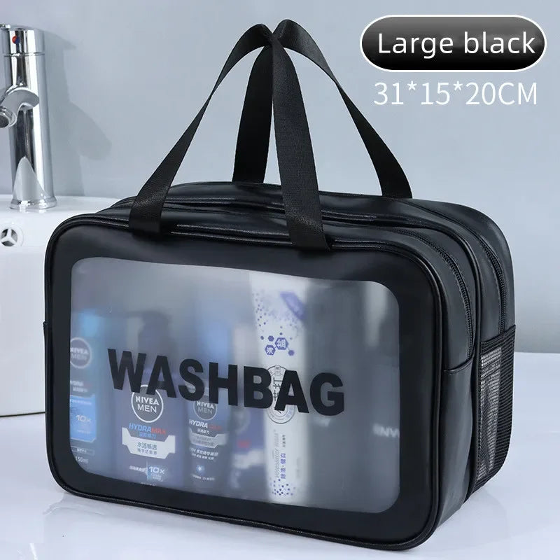 Black washbag with transparent front panel displaying products, placed on a white surface with a bathroom background.