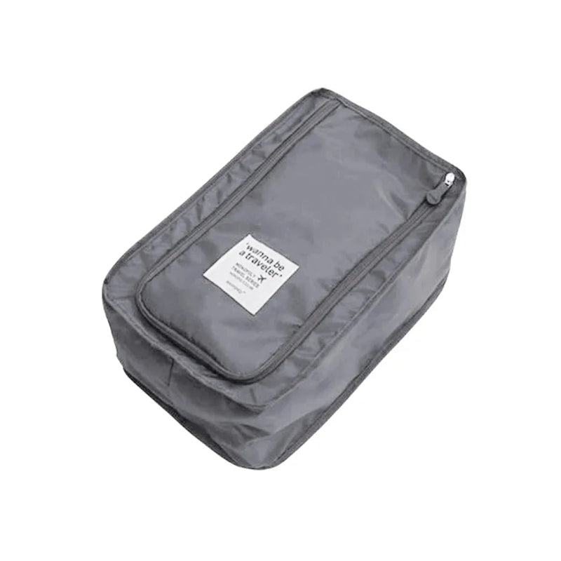 Gray travel toiletry bag with a label on a white background