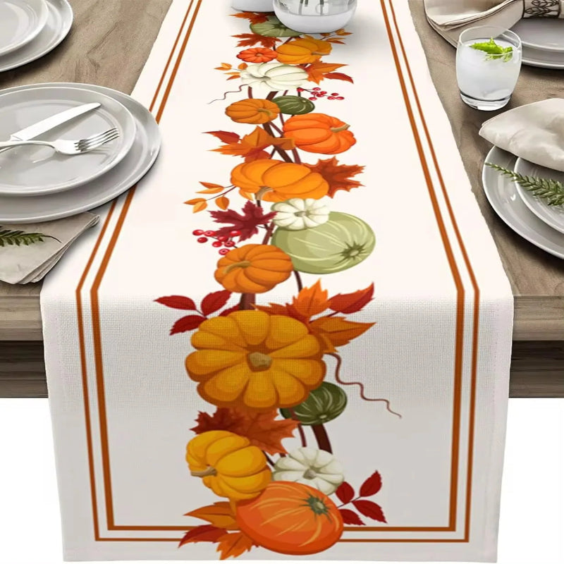 Table runner with autumn design featuring pumpkins and leaves on a set table.