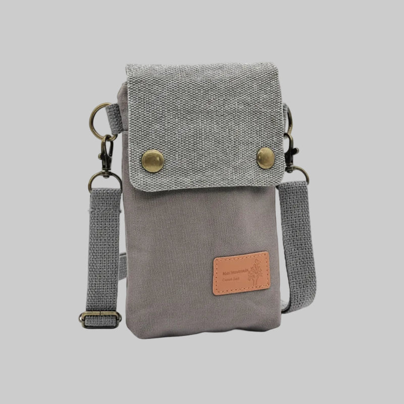 Gray crossbody bag with a strap on a white background