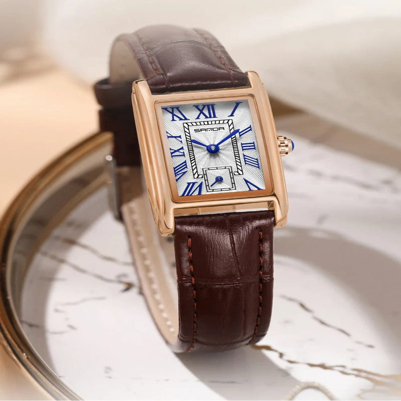 Elegant retro watch with brown leather strap on a marble surface