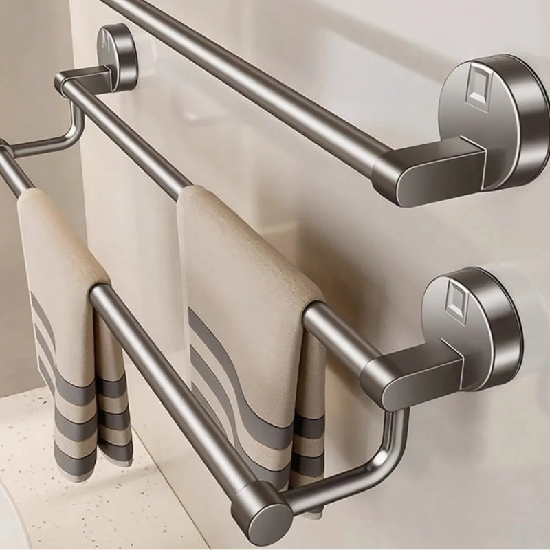 A wall-mounted double towel bar set in brushed silver metal, shown holding two beige towels with gray stripes. The brand name 'RUITHOE' is printed in bold black letters across the top.