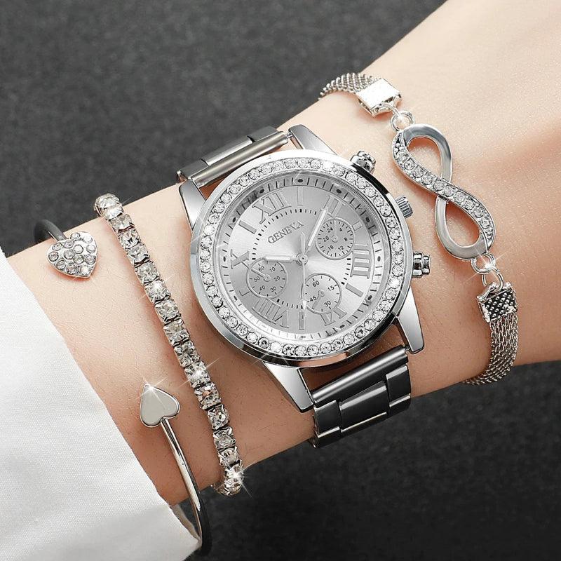 Silver watch with decorative bracelets on a wrist against a dark background