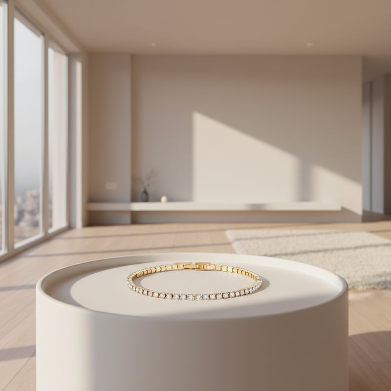 Gold bracelet with clear stones on a white background