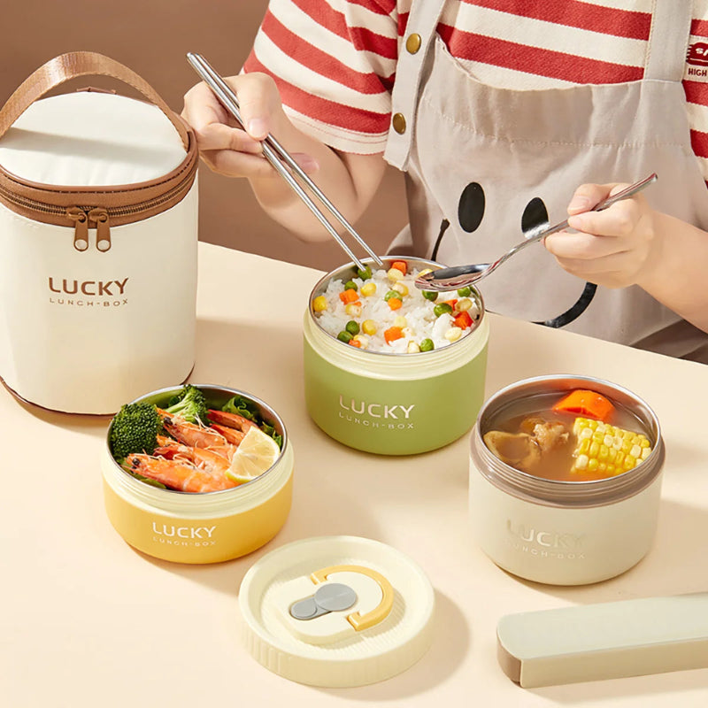 Person using a set of 'Lucky' lunch containers with various food items on a table.
