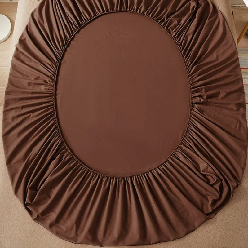 Brown fitted sheet on a bed with 'vave' branding.