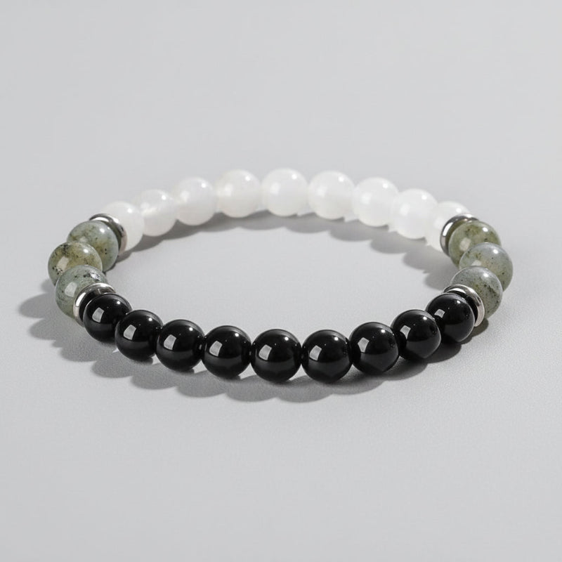 Beaded bracelet with black, white, and green stones on a wooden surface with 'Self-Love' text.