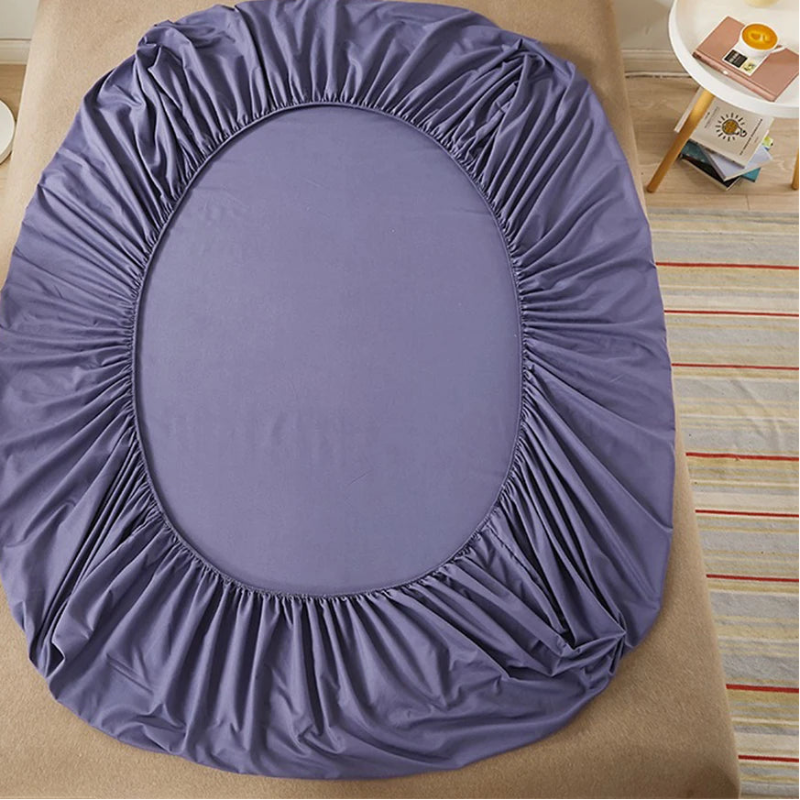 Purple fitted sheet on a bed with 'vave' branding.