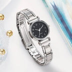 Silver watch with a black dial on a light background