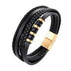 Black braided leather bracelet with gold accents on a white background
