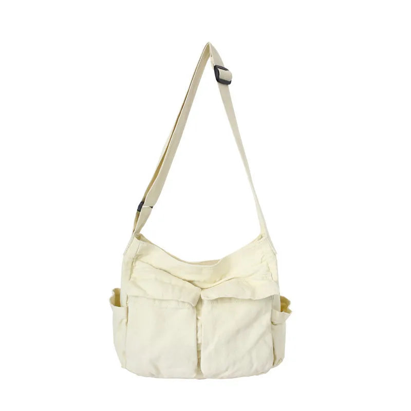 Beige shoulder bag with multiple pockets on a white background