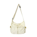 Beige shoulder bag with multiple pockets on a white background