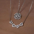 Silver necklace with heart-shaped pendants on a brown background