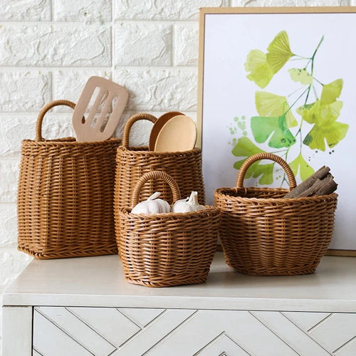Set of wicker baskets on a white surface with a decorative painting in the background.