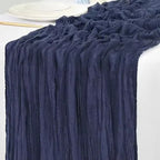 Navy blue crumpled table runner on a white tablecloth