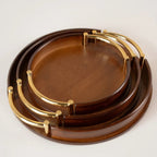 Set of wooden trays with gold accents on a white background