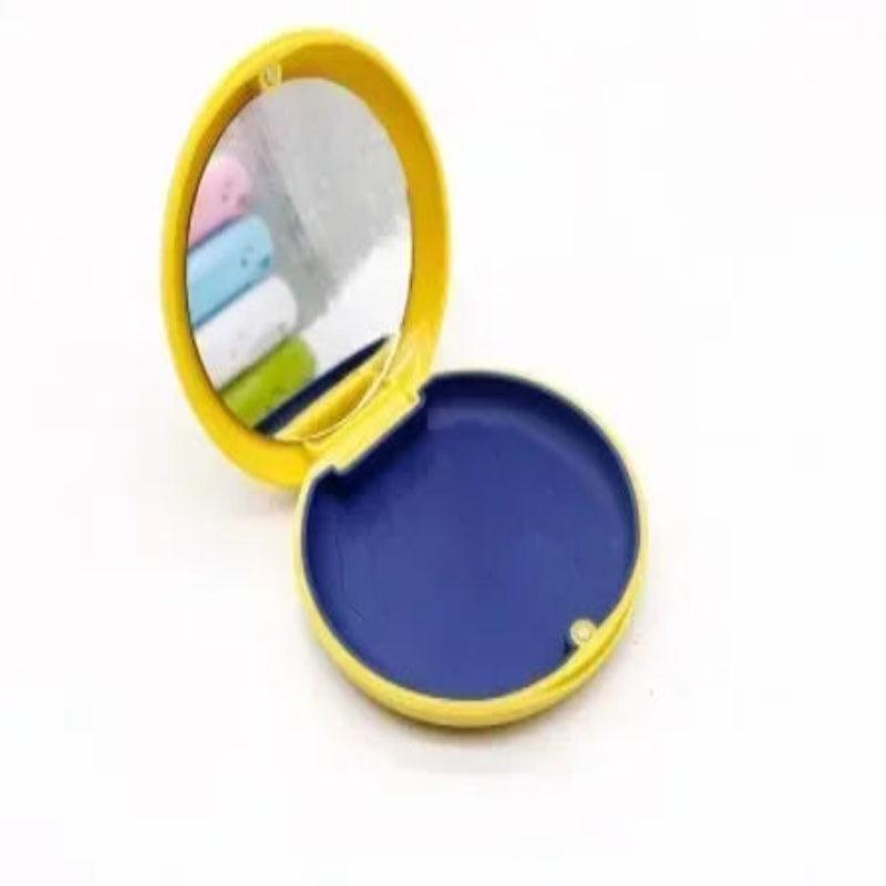 Compact mirror with colorful lenses on a white background