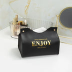 Black pouch with 'ENJOY' text on a white surface with cosmetic items in the background